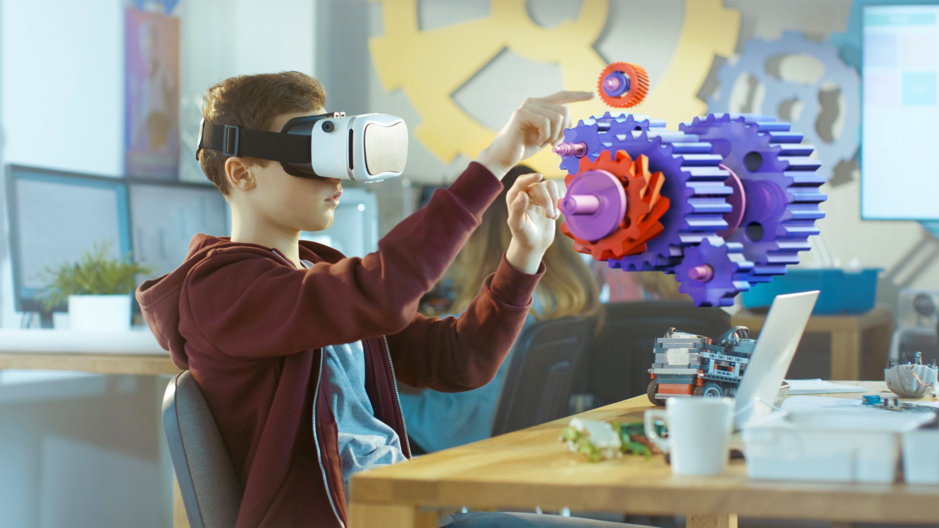 In a Computer Science Class Boy Wearing Virtual Reality Headset Works in Interactive 3D Environment. Mechanical Modeling Project of Connecting Gears with Augmented Reality Software.